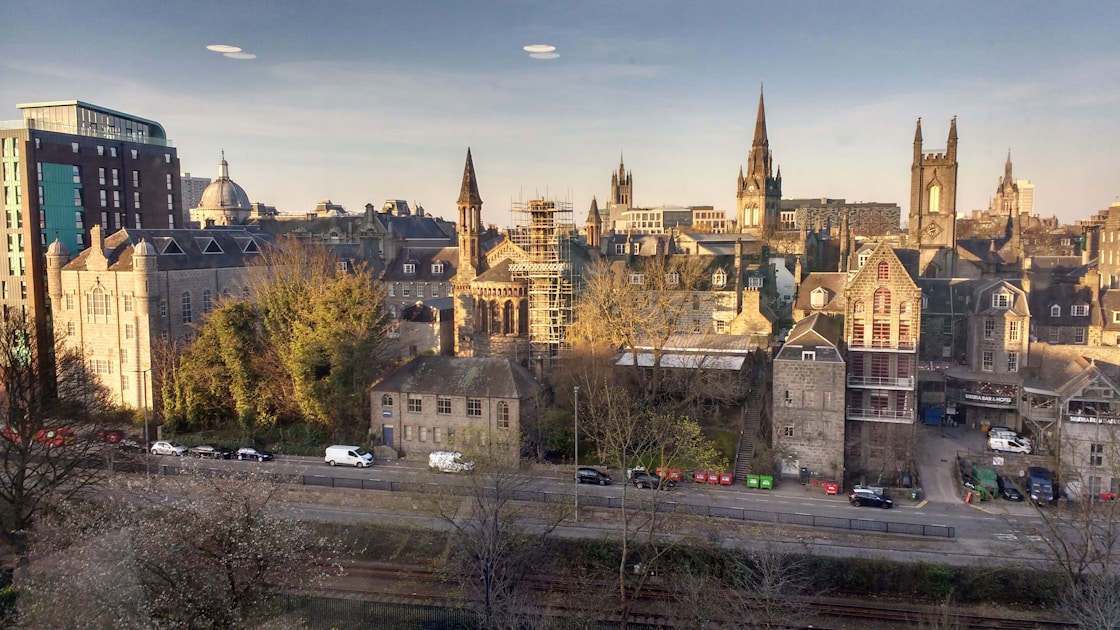 a view of a city with a train on the tracks