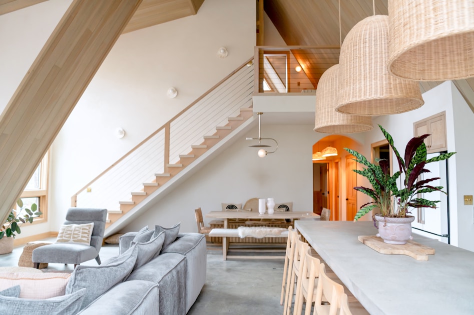 A living room filled with furniture and a staircase
