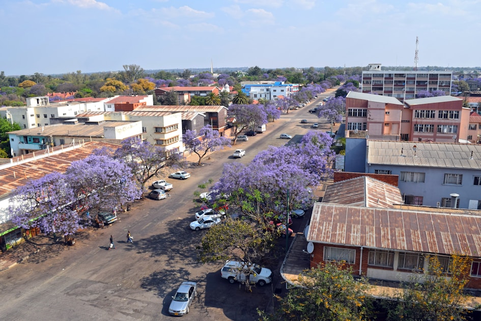 A view of a street with cars parked in front of buildings