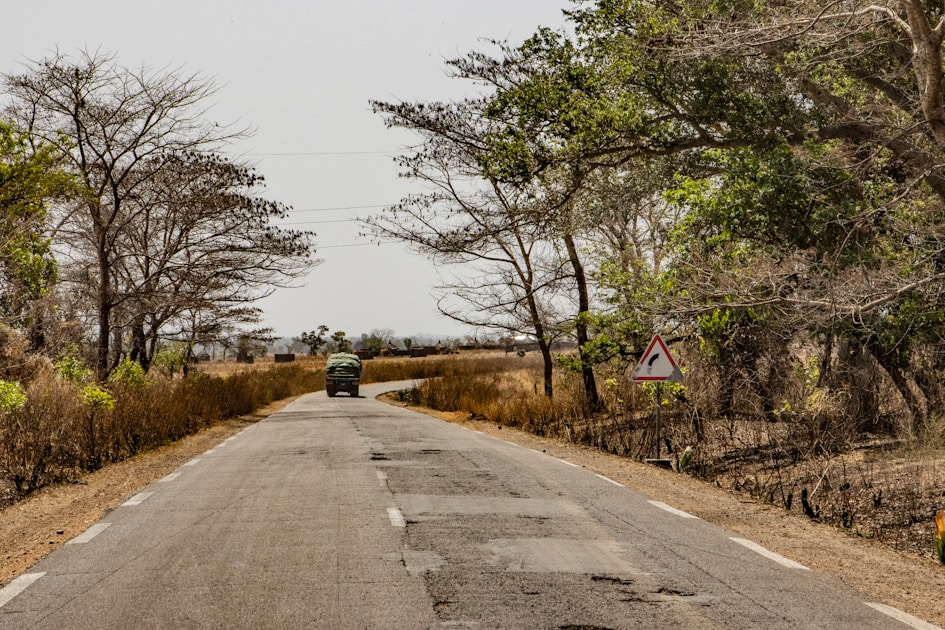 a car is driving down a deserted road