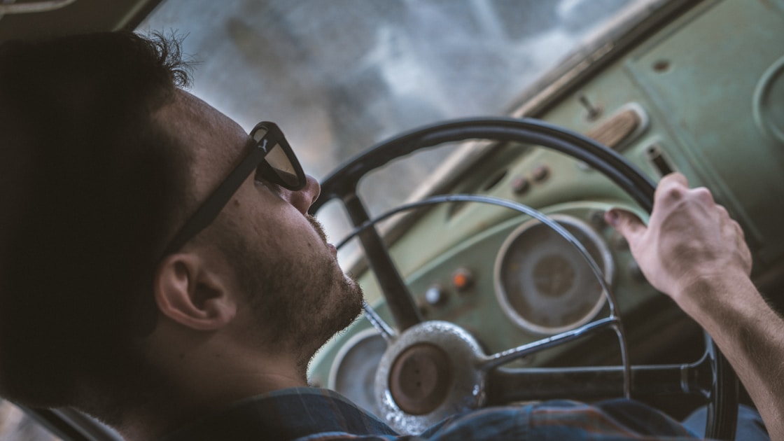 person holding steering wheel