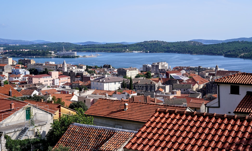 aerial view of city buildings near body of water during daytime