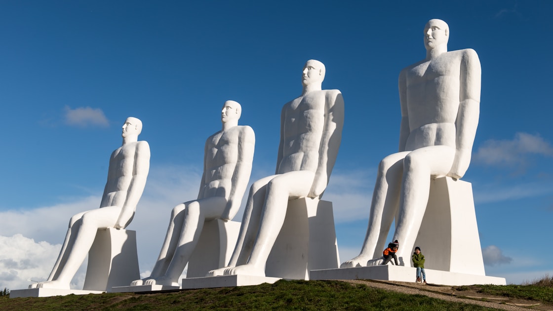 A group of white statues sitting on top of a hill