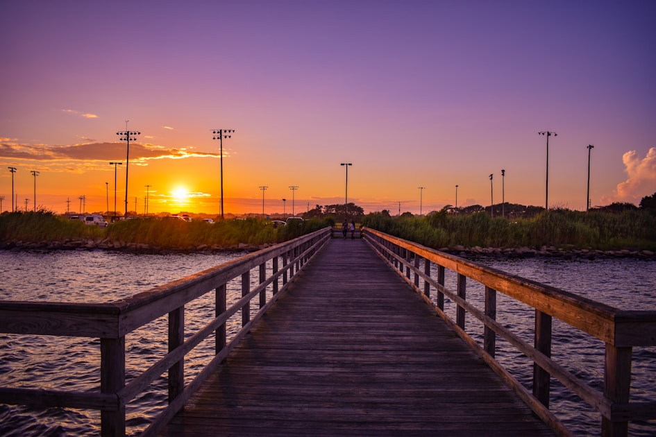 brown wooden dock during sunset