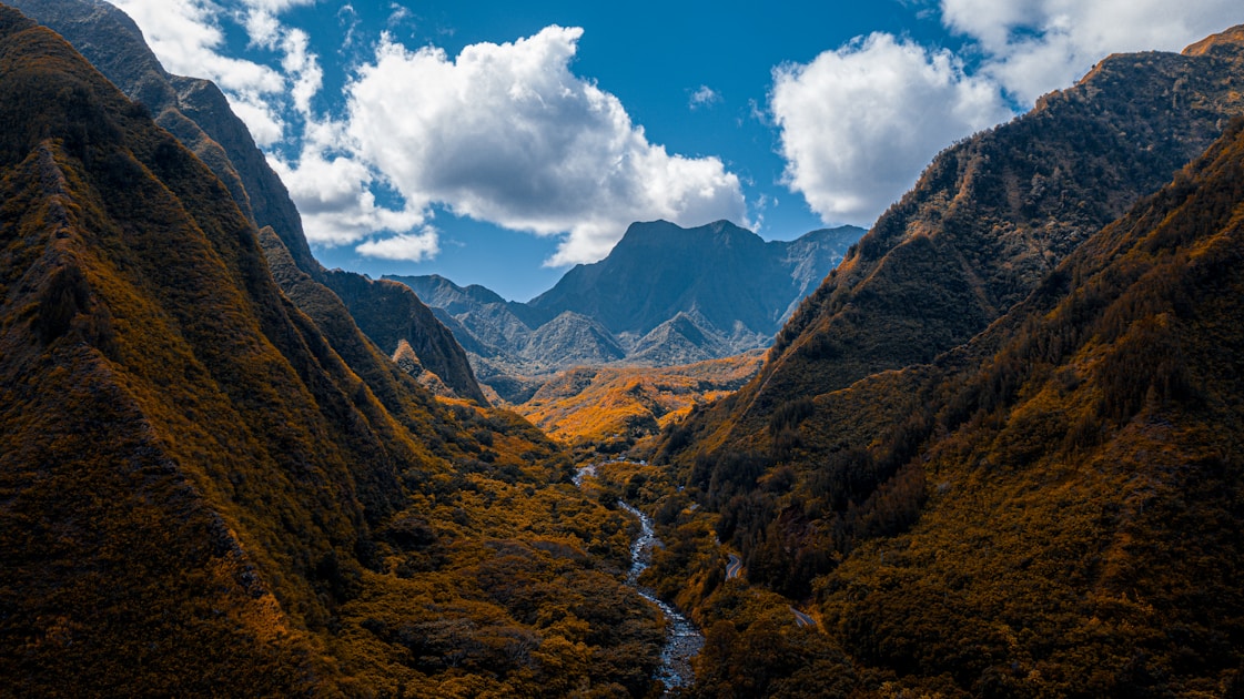 green and brown mountains under blue sky and white clouds during daytime