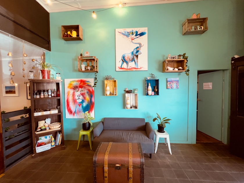 a living room filled with furniture and pictures on the wall