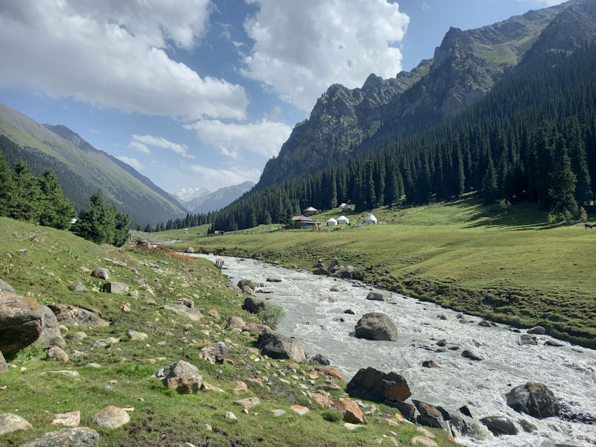 A river flows through a green valley.