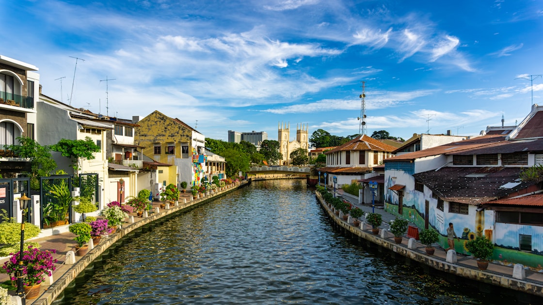 A river running through a city next to tall buildings