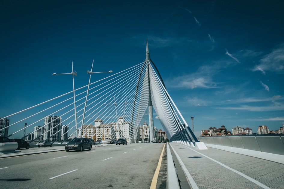 cars on road under blue sky during daytime