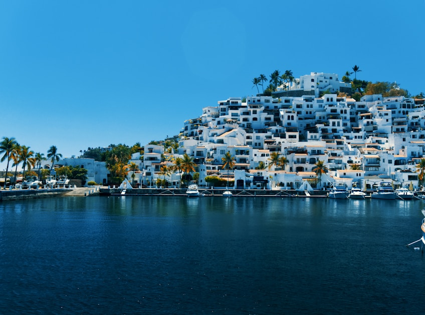 city buildings near body of water during daytime
