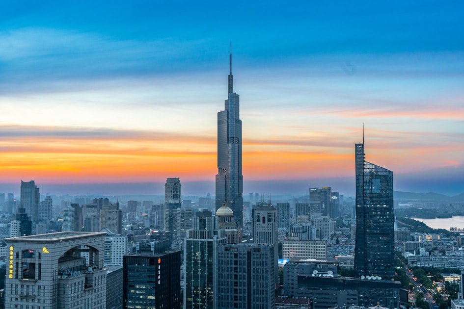 A view of a city at sunset from the top of a building