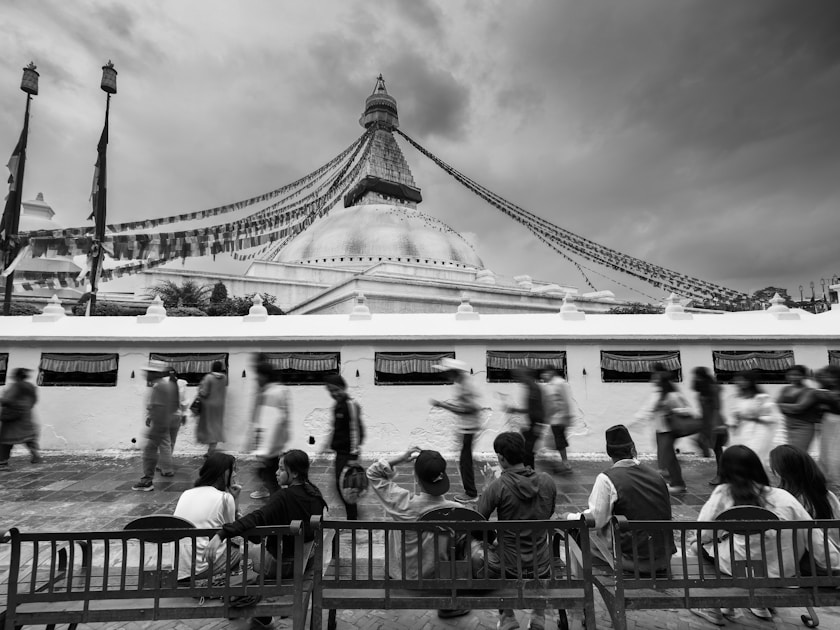 a group of people sitting on top of a wooden bench