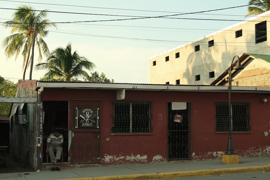 a man standing outside of a red building
