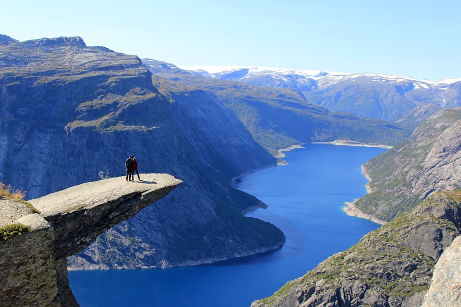 a person standing on a cliff overlooking a body of water