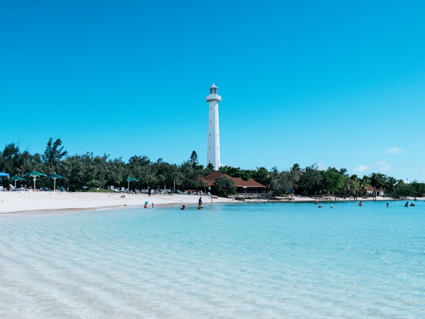 A beach with a light house in the background