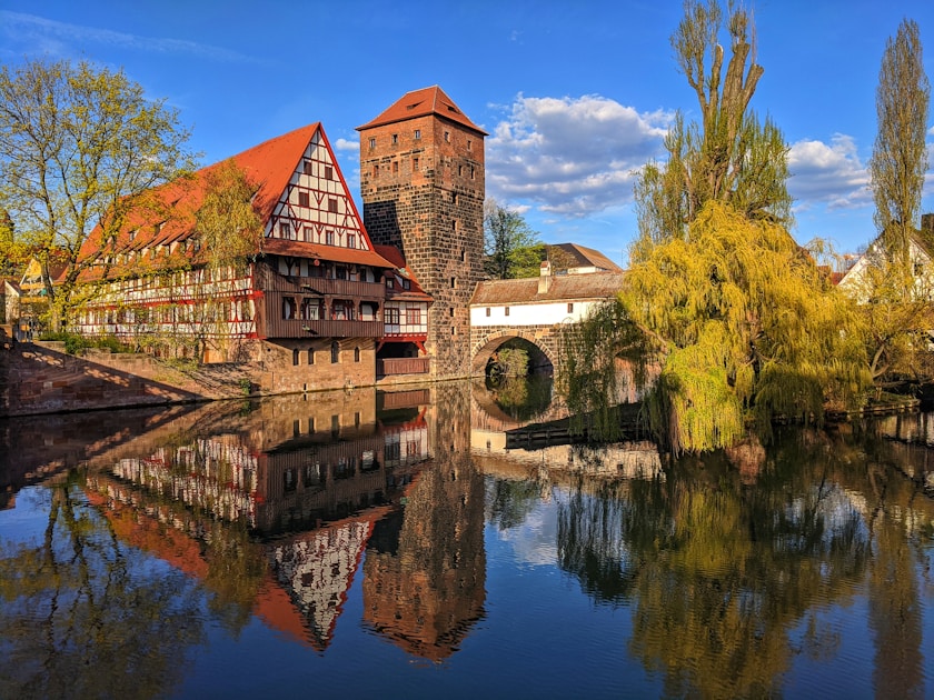 brown brick building near body of water during daytime