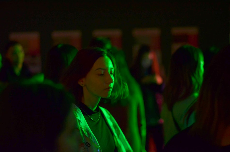 a group of people standing around each other in a room