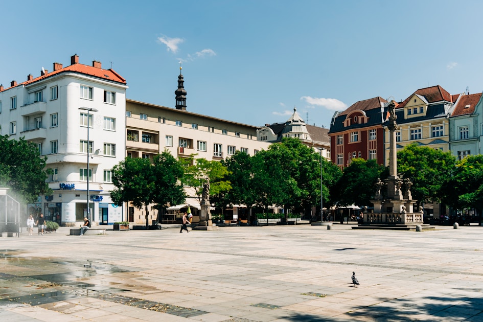 a city square with a fountain in the middle of it