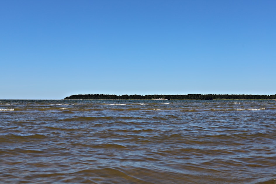 A body of water with a small island in the distance