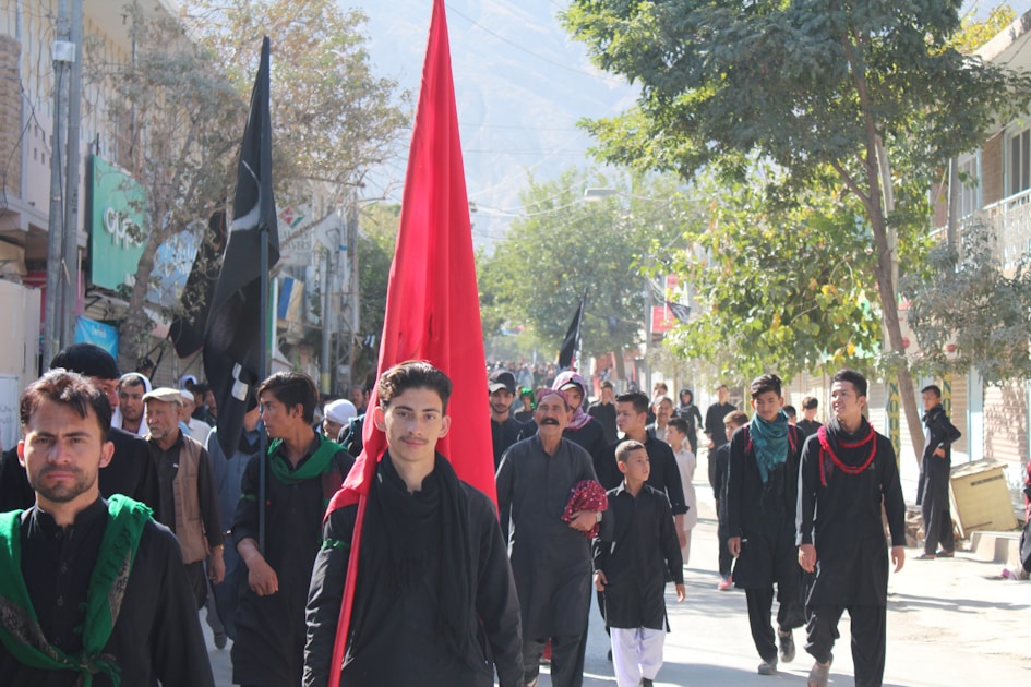 group of men wearing black traditional suit