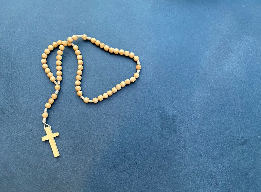 a rosary with a wooden cross on it