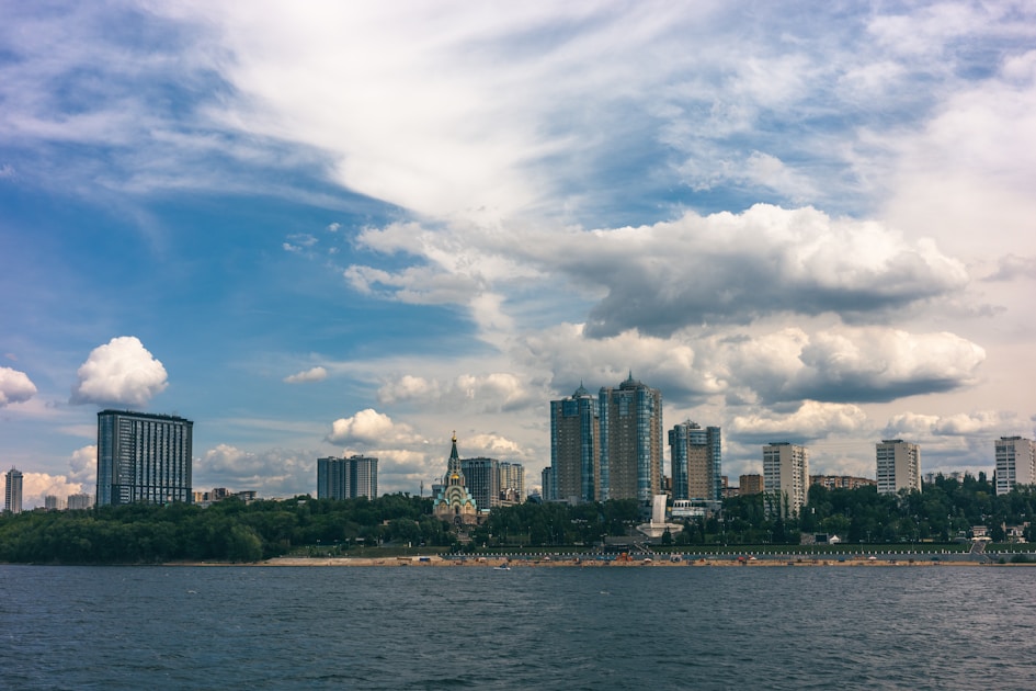 a large body of water with a city in the background