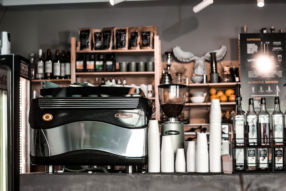 black and gray corded machine beside bottles