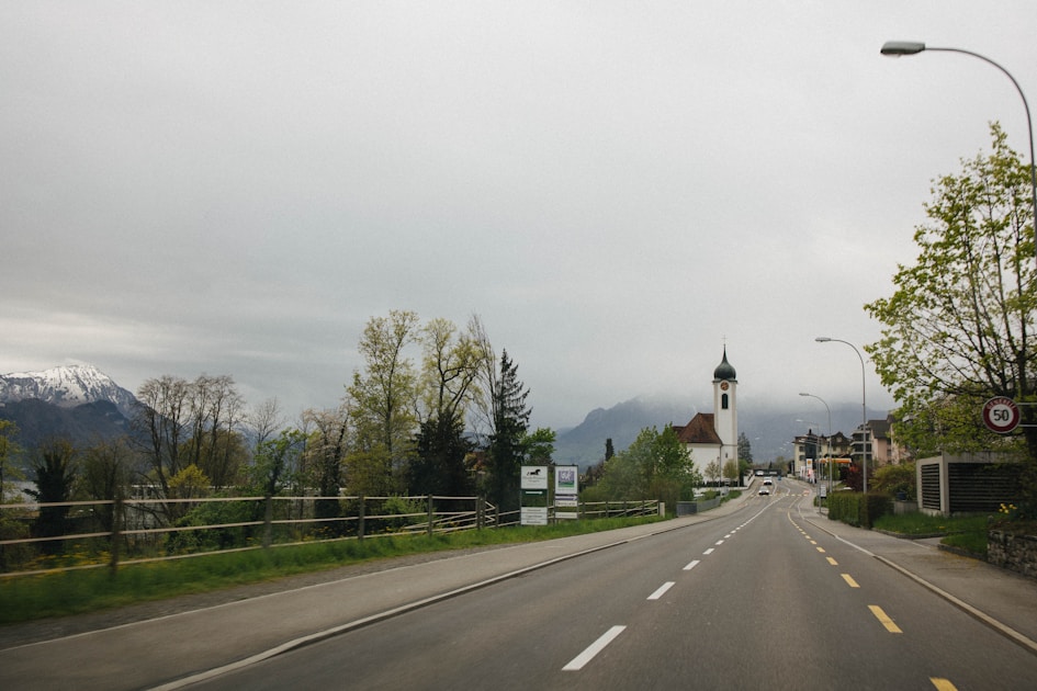 a long road with a church in the distance