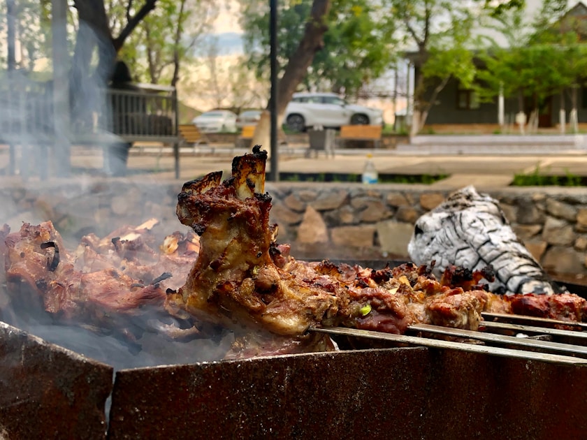 A bbq grill with a bunch of food on it
