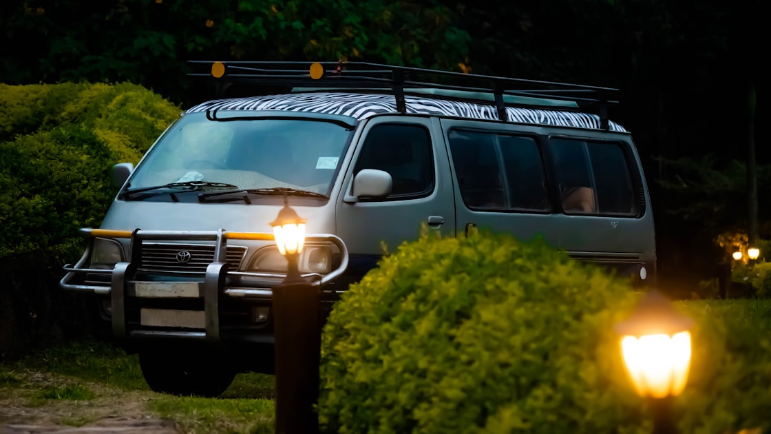 a van is parked in the dark with its lights on