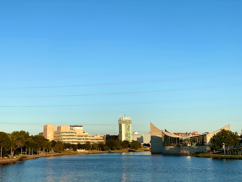 A body of water with buildings in the background